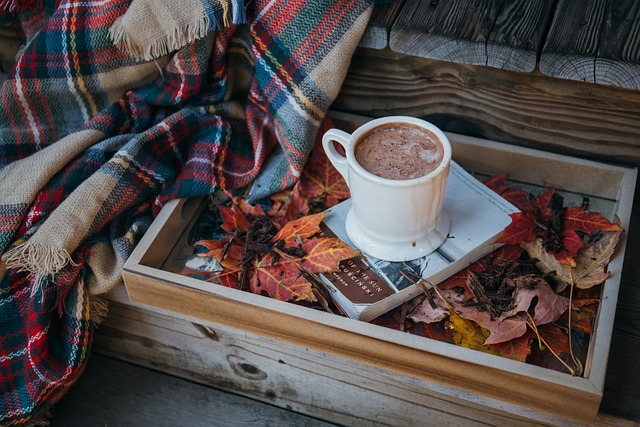 An image showcasing a steaming mug of hot chocolate topped with a mountain of fluffy marshmallows, surrounded by a cozy winter wonderland
