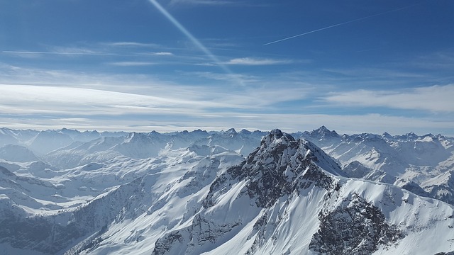 An image showcasing a snowy mountain landscape with gentle slopes tailored for young skiers