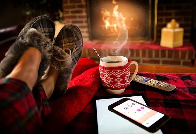 An image showcasing a cozy living room with a crackling fireplace, snowflakes falling outside the window, and a family of animated characters gathered around a TV, engrossed in the magic of classic winter-themed animated movies