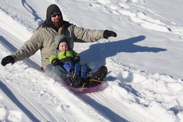 An image capturing the exhilaration of sledding down a steep, tree-lined hill